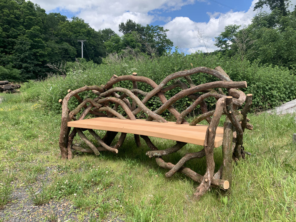 Outdoor rustic park bench built using mountain laurel trees and branches titled the Mountain Laurel Bench