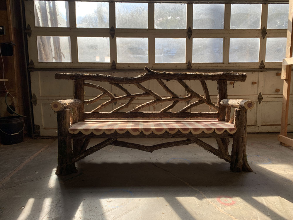 Rustic bench custom built using cedar trees and branches titled the Rhinebeck Bench