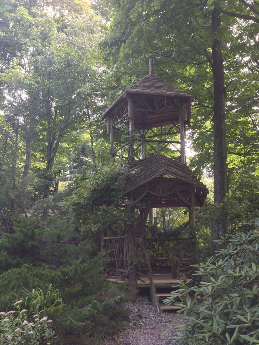 Outdoor two story gazebo built in the rustic style using logs and branches titled the Down to Earth Tree Tower
