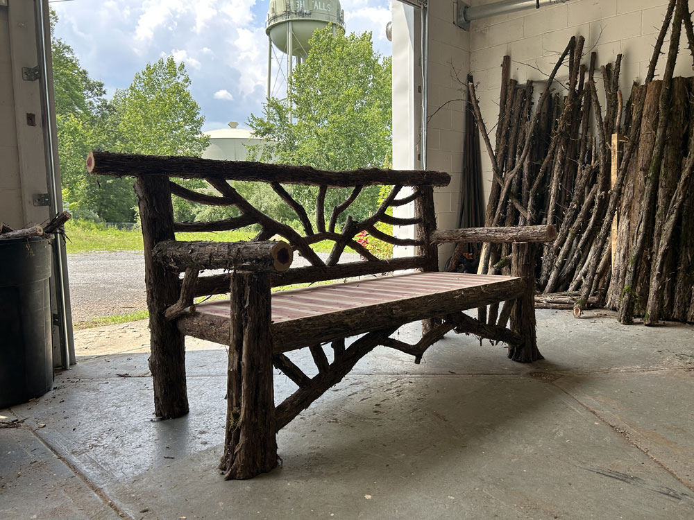 Outdoor rustic garden bench built using bark-on trees and branches titled the Catskill Butterfly Bench