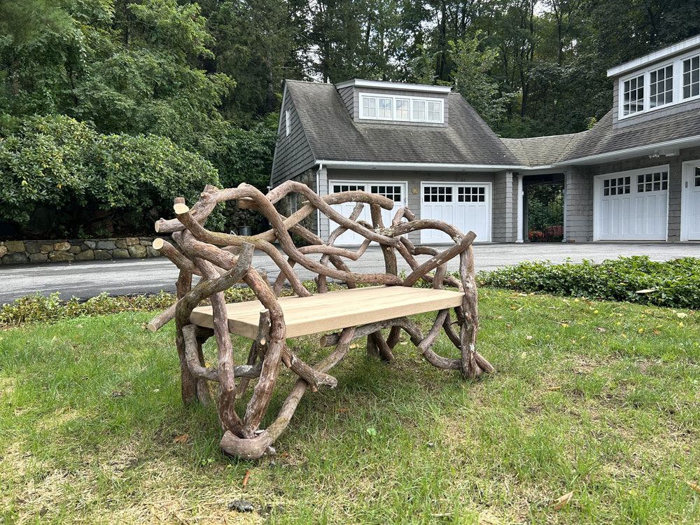 Outdoor rustic park bench built using mountain laurel trees and branches titled the Persky Laurel Bench
