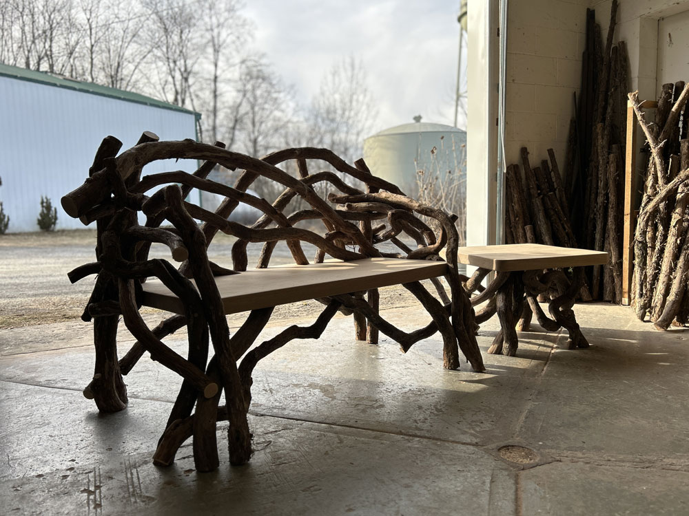 Outdoor rustic bench built using mountain laurel trees and branches titled the Benson Bench & Table