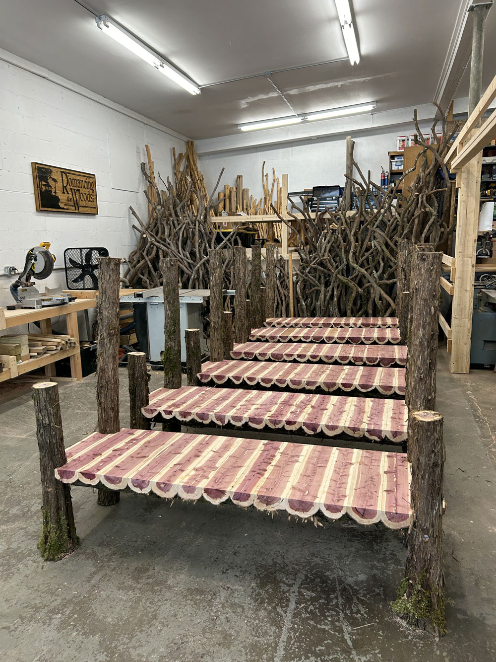 Outdoor park bench built in the rustic style using logs and branches titled the Mohonk Putnam Bench