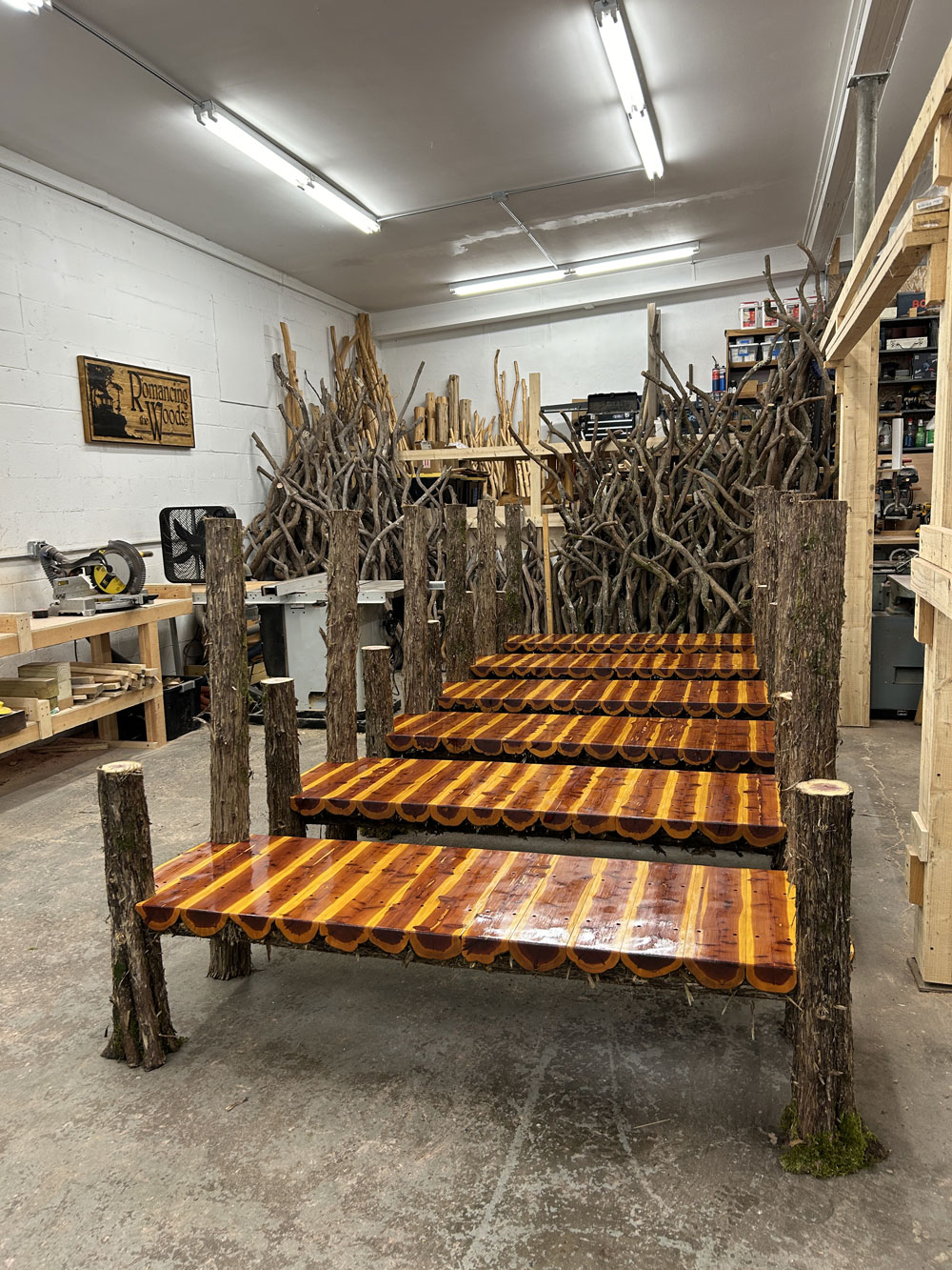 Outdoor park bench built in the rustic style using logs and branches titled the Mohonk Putnam Bench