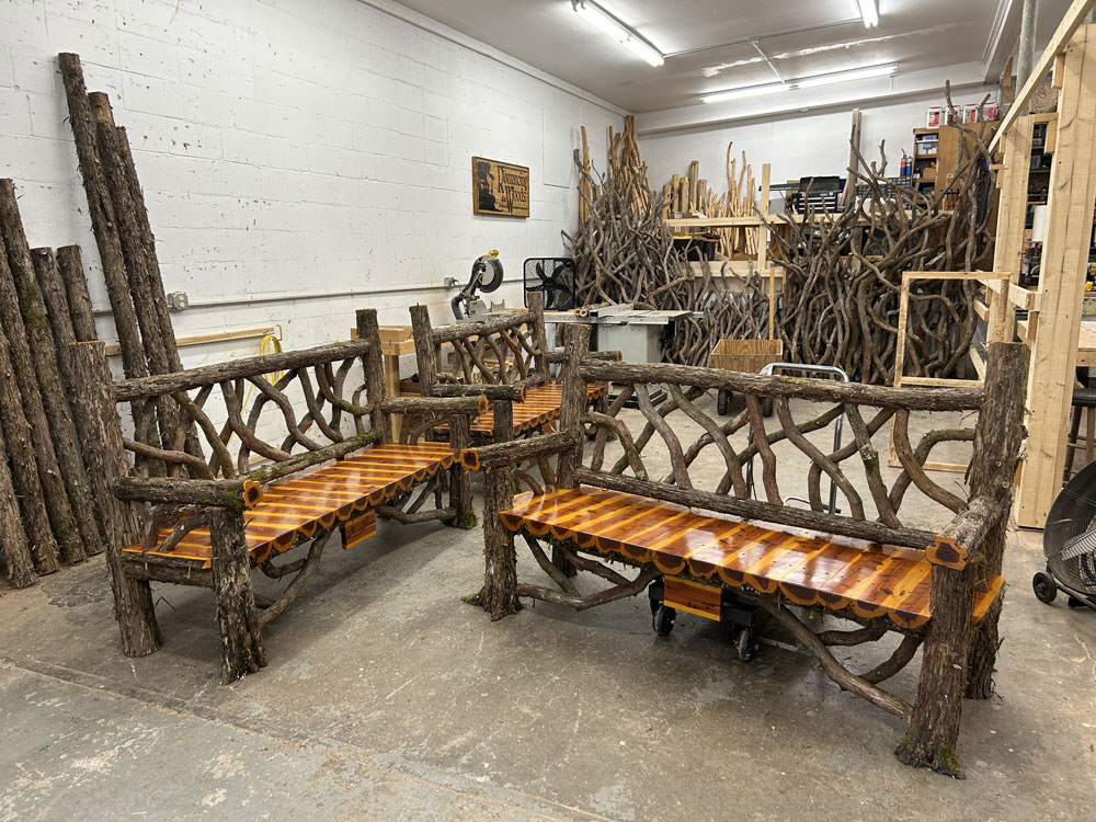 Outdoor park bench built in the rustic style using logs and branches titled the Mohonk Putnam Bench