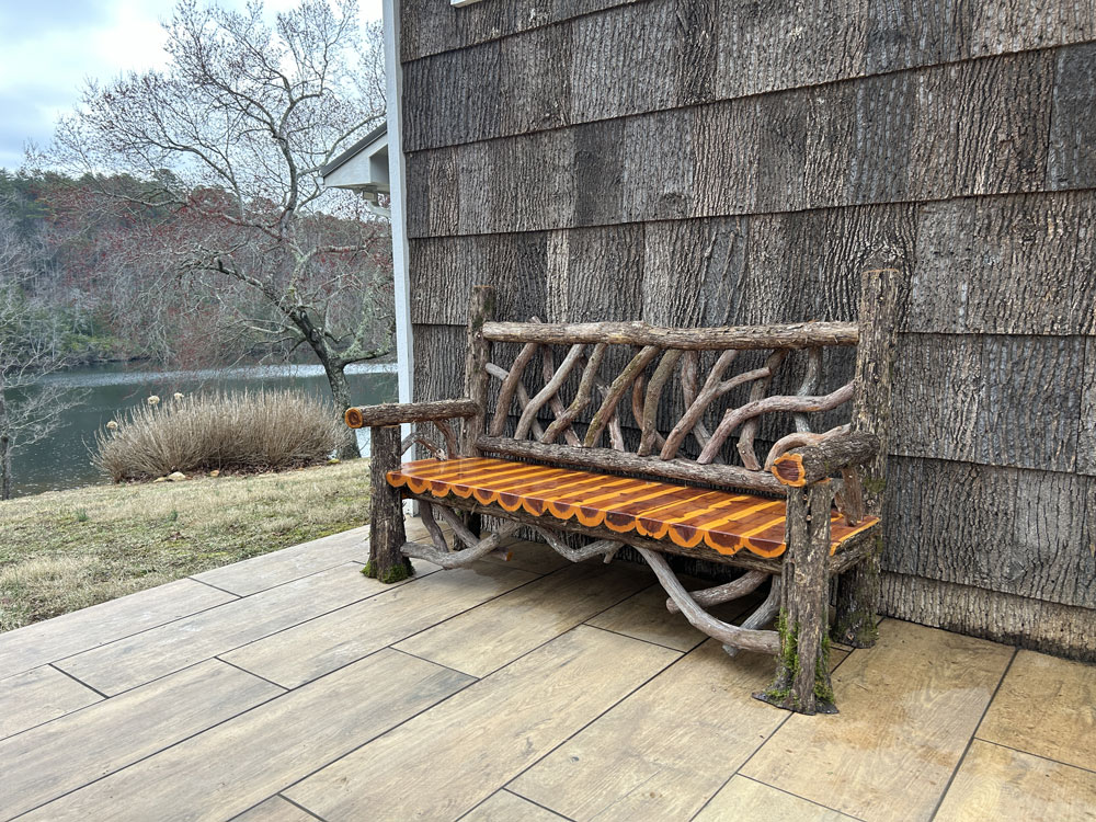 Outdoor rustic garden bench built using bark-on trees and branches titled the Putnam Bench 