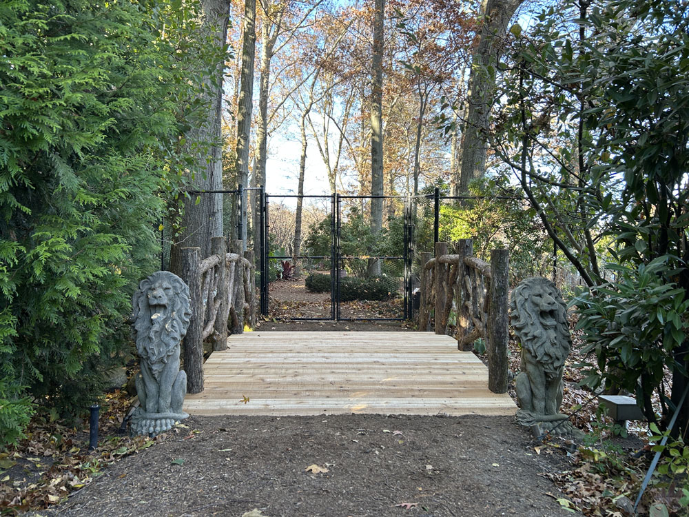 Rustic bridge custom built using cedar trees and branches titled the Tyson Bridge