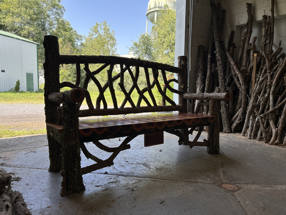 Exterior twig bench built from cedar logs titled the Mohonk Bench
