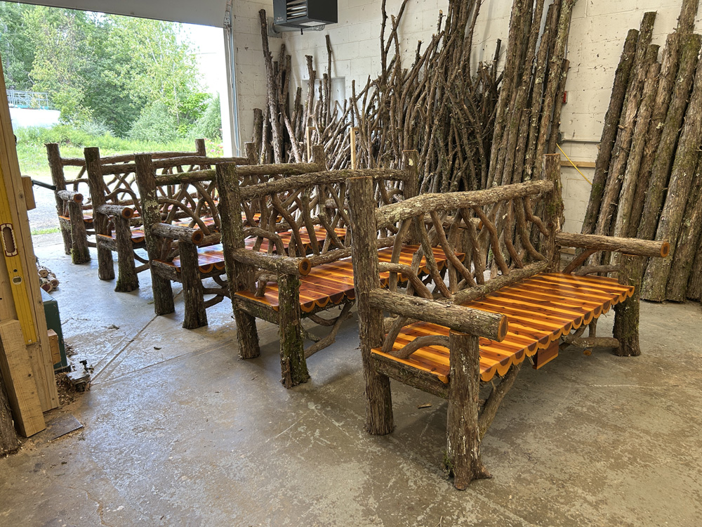 Outdoor park bench built in the rustic style using logs and branches titled the Mohonk Bench