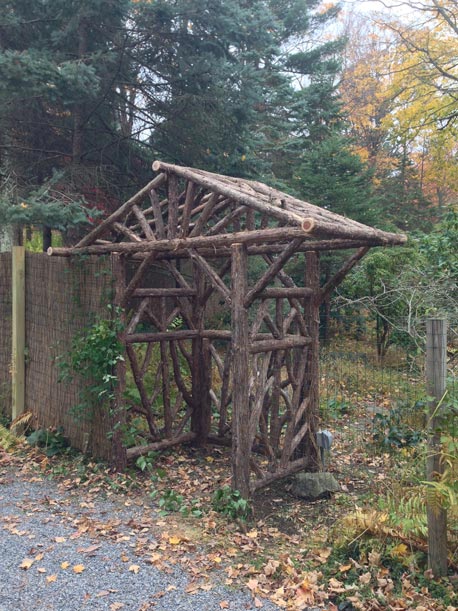 Rustic natural arbor made from bark-on cedar logs, twigs, and branches titled the Engel Hudson Arbor & Gate