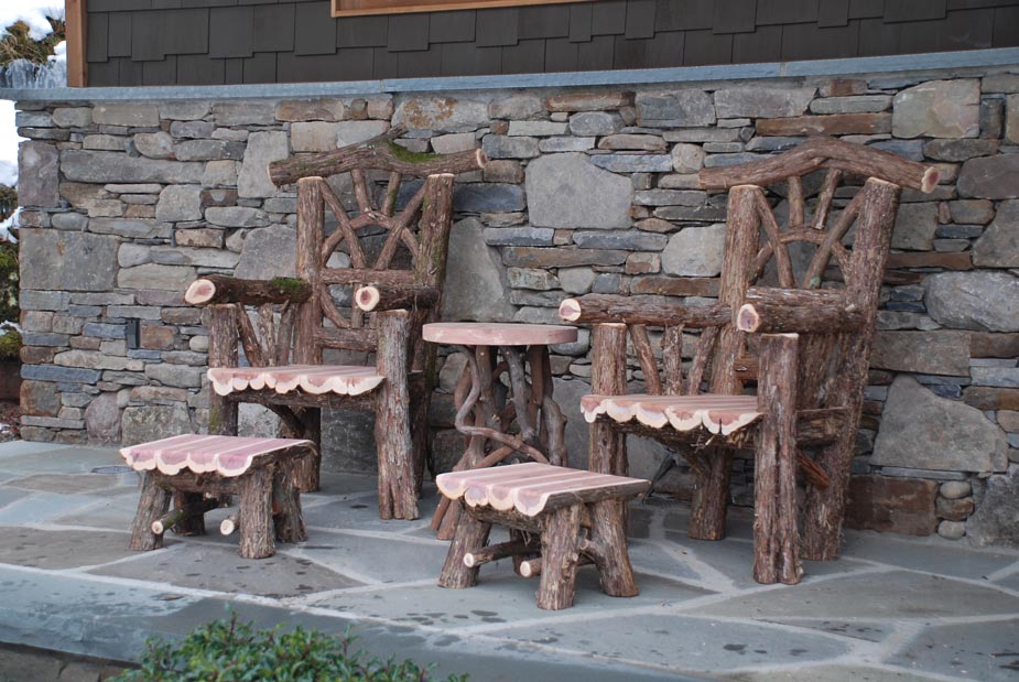 Outdoor rustic garden chairs built using bark-on trees and branches titled the Windham Chairs, Ottomans and Table