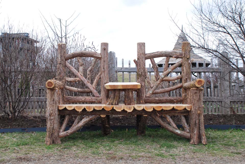 Natural wood bench swing built with trees and branches titled the Midler Couples Bench