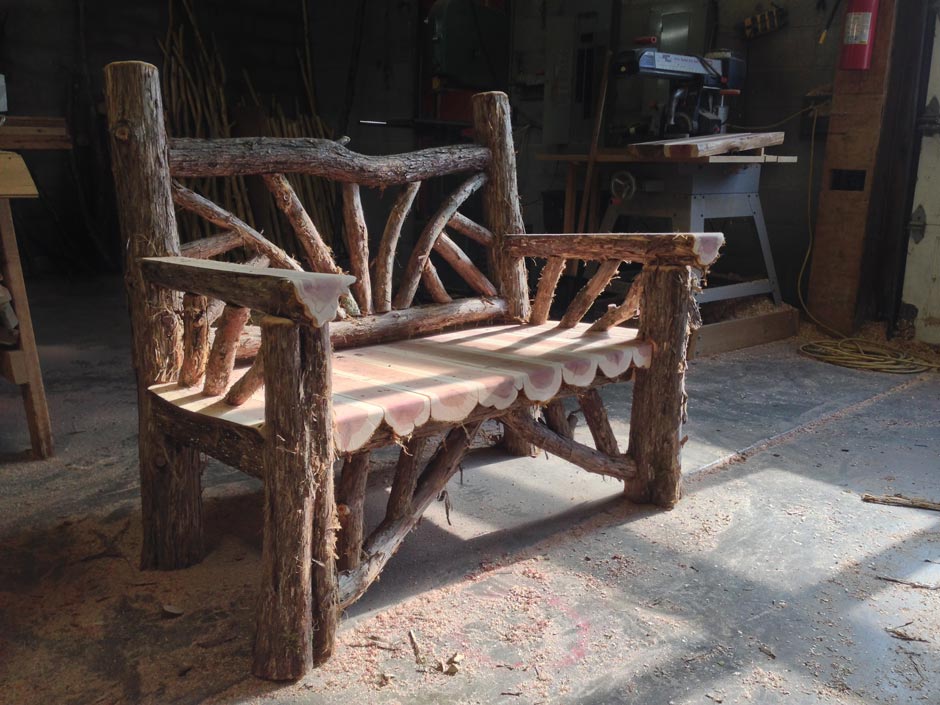 Exterior twig bench built from cedar logs titled the Midler Taconic Bench
