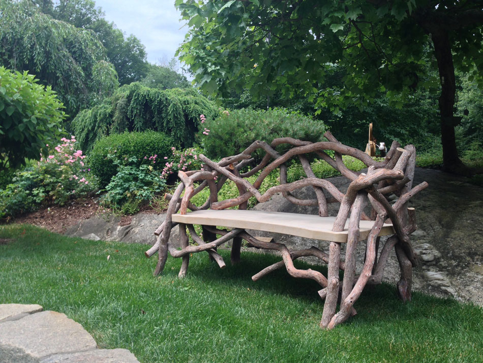 Outdoor rustic park bench built using mountain laurel trees and branches titled the Benson Bench 2016