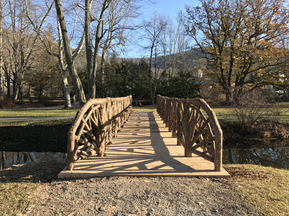 Rustic bridge railings custom built using cedar trees and branches titled the Kirkside Park Bridge 2016