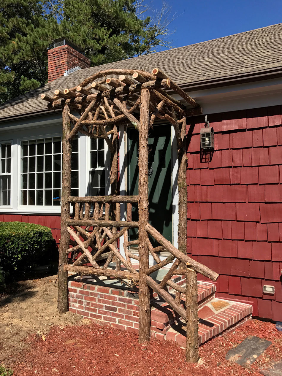 Branchwork rustic arbor constructed using natural materials titled the Melikan Entrance Arbor