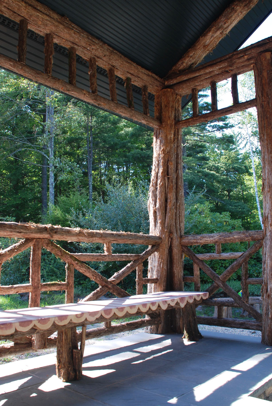 Railings built in the rustic style using logs and branches titled the Bearsville Benches