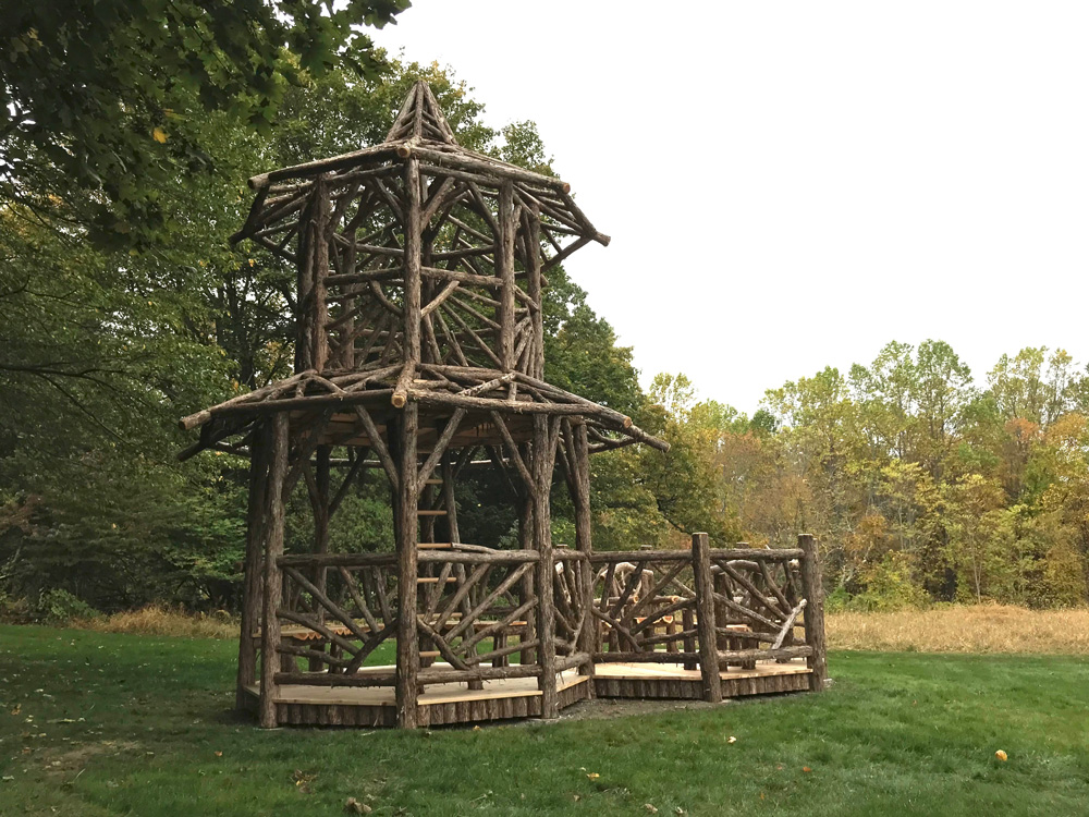 Outdoor rustic tree tower built using bark-on trees and branches titled the Taunton Hill Tree Tower