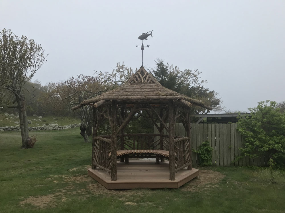 Rustic gazebo built in the rustic style using logs and branches titled the Fishers Island Gazebo