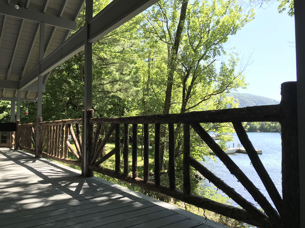 Rustic railings custom built using cedar trees and branches titled the Porch Railings at Hullets Landing