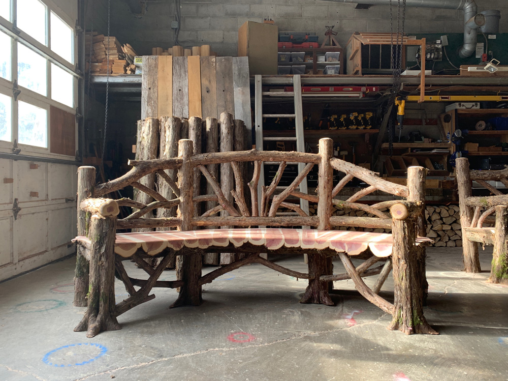 Exterior twig bench built from cedar logs titled the Poet's Bench