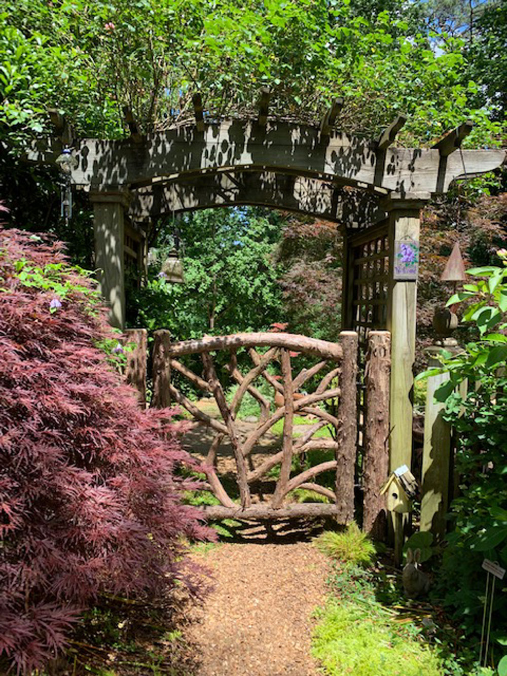 Rustic gates built using bark-on trees and branches titled the Yaeger Gates
