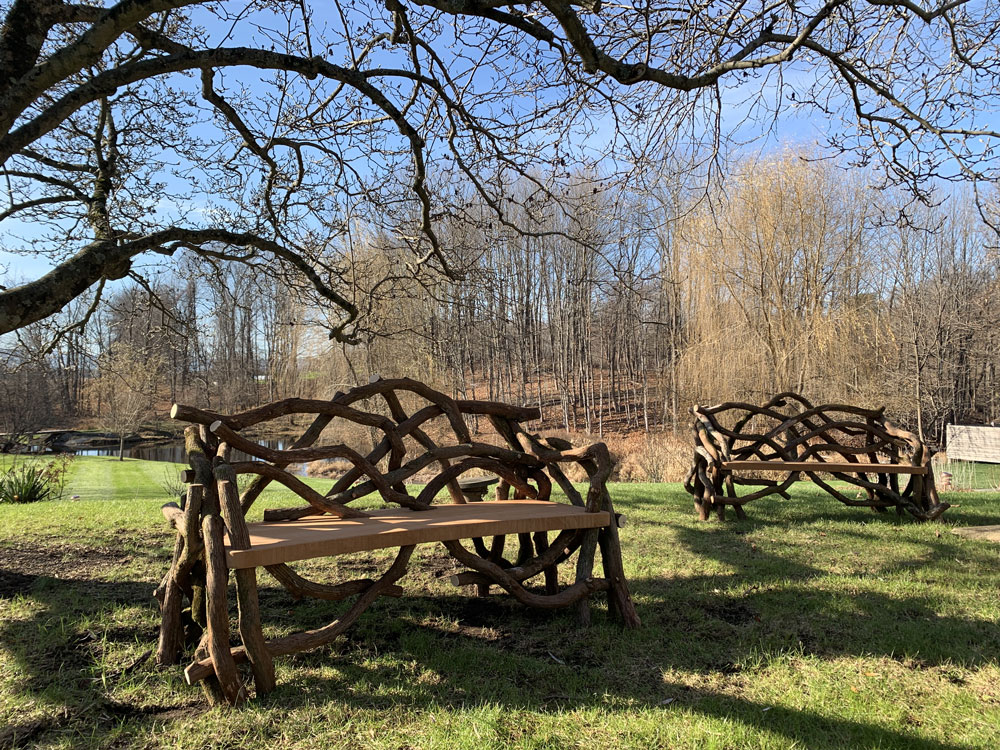 Outdoor rustic park bench built using mountain laurel trees and branches titled the Salgardo Benches