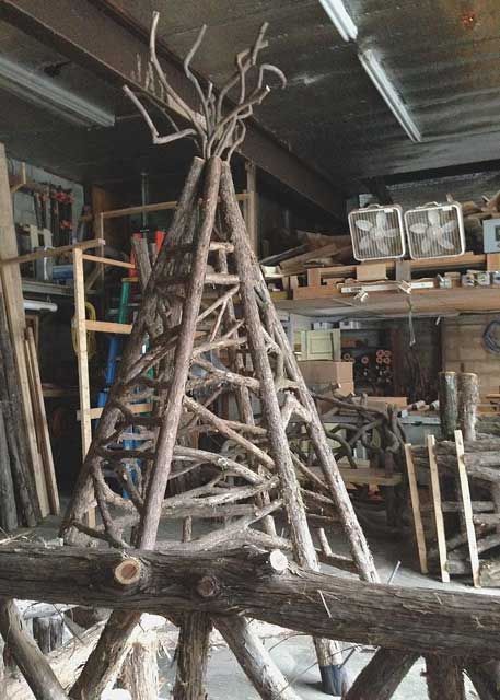 Rustic tepee custom built using cedar trees and branches titled the Easton Children's Museum Teepee