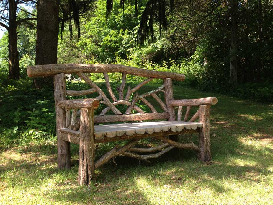 Exterior twig bench built from cedar logs titled the Catskill Butterfly Bench