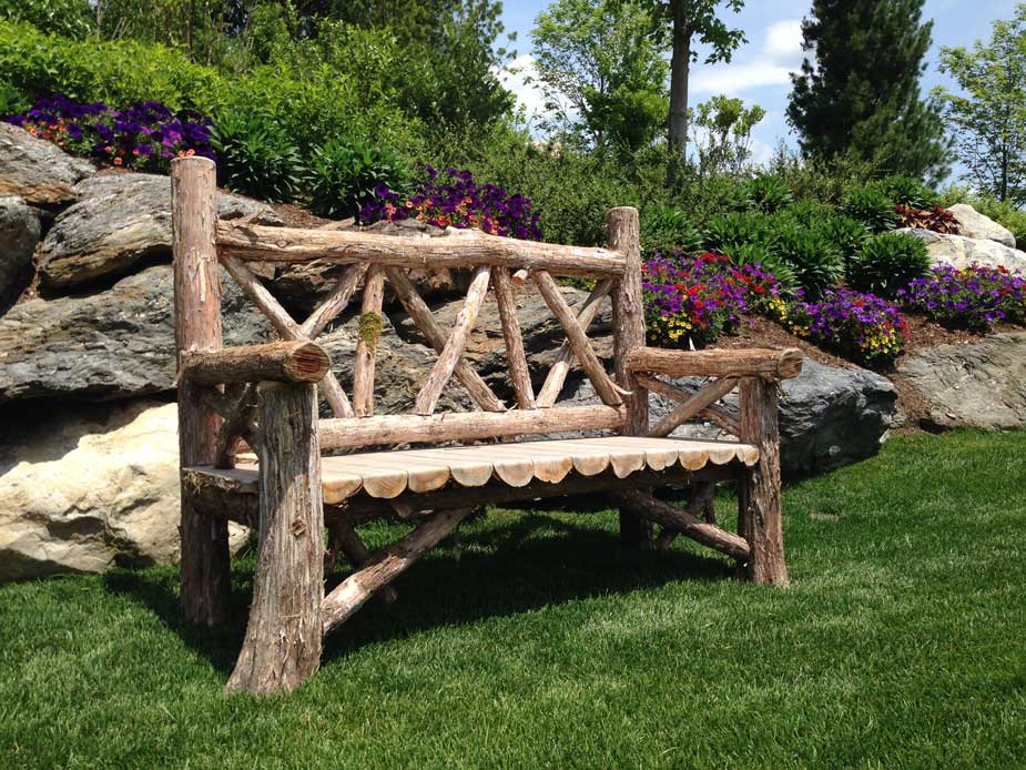 Outdoor rustic garden bench built using bark-on trees and branches titled the  Milan Bench