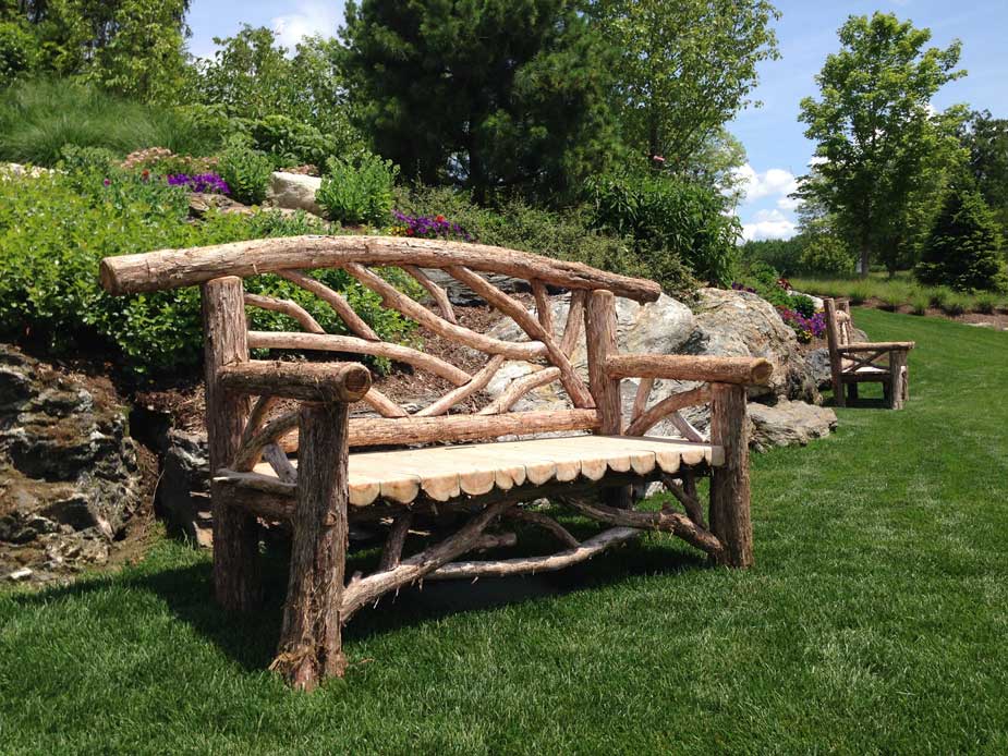 Outdoor park bench built in the rustic style using logs and branches titled the Rhinebeck Bench