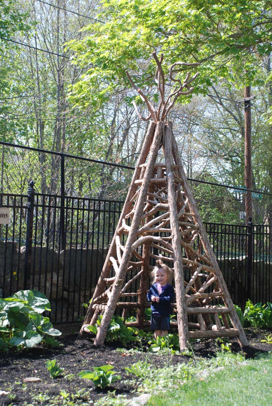 Outdoor tepee in the rustic style using logs and branches titled the Easton Tepee