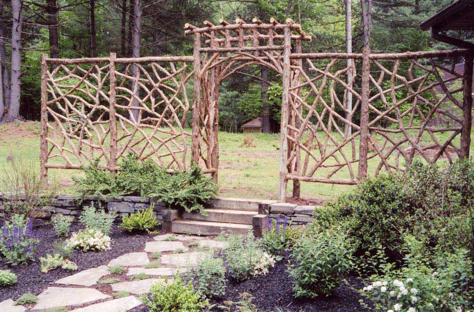 Branchwork rustic arbor and fencing constructed using natural materials titled the Carmel