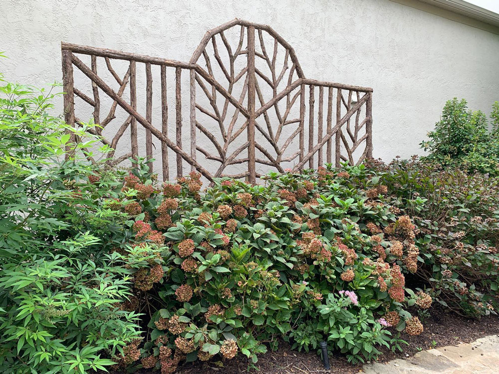 Rustic natural trellis made from bark-on cedar logs, twigs, and branches titled the Villanova