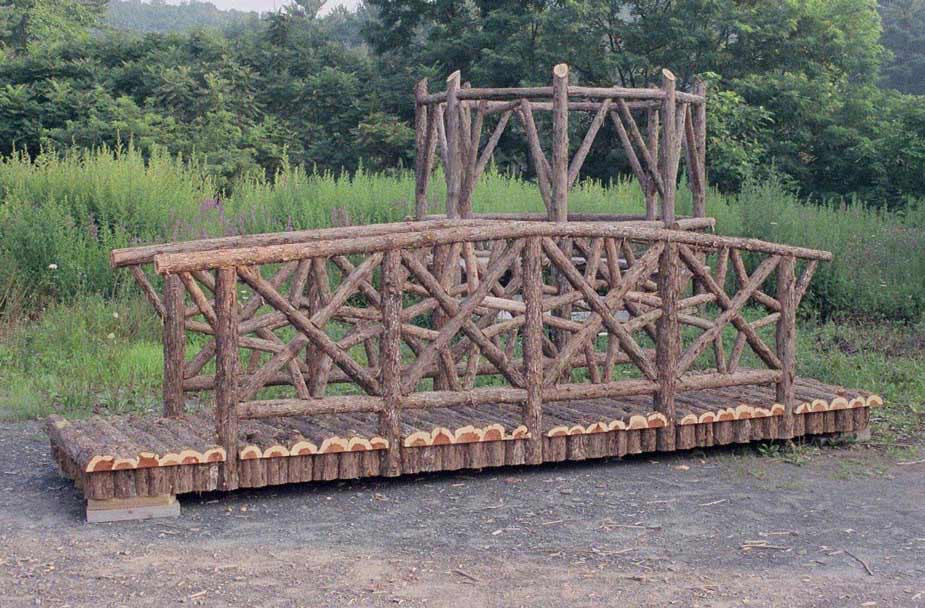 Natural wood bridge ready to ship built with trees and branches titled the Dallas Bridge