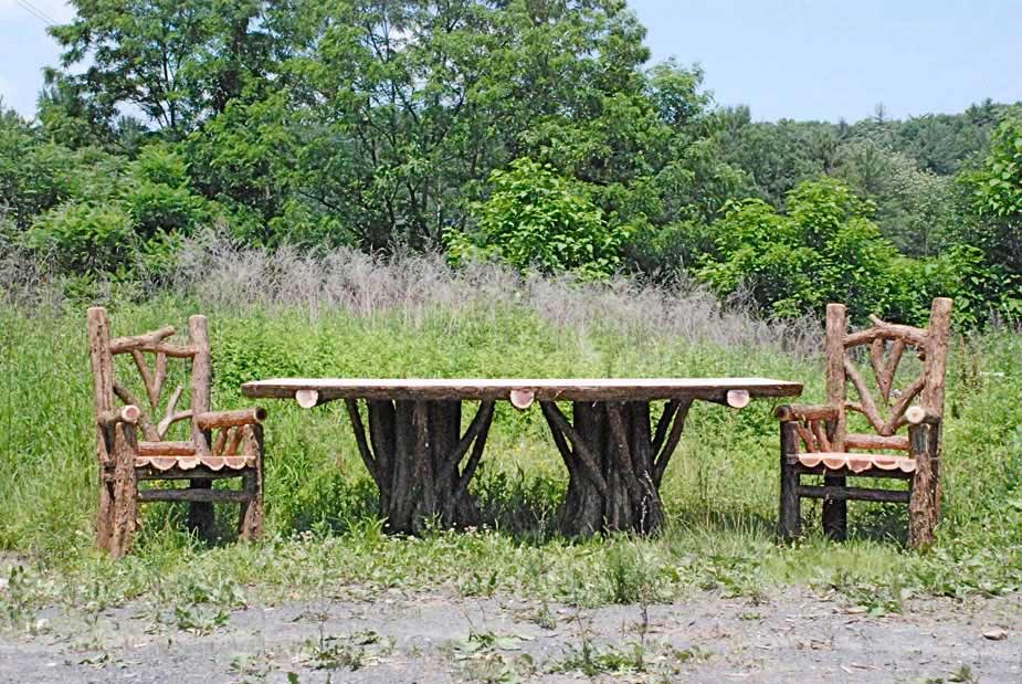 Outdoor rustic patio chairs and table set built using bark-on trees and branches titled the Lamondo Dining Set