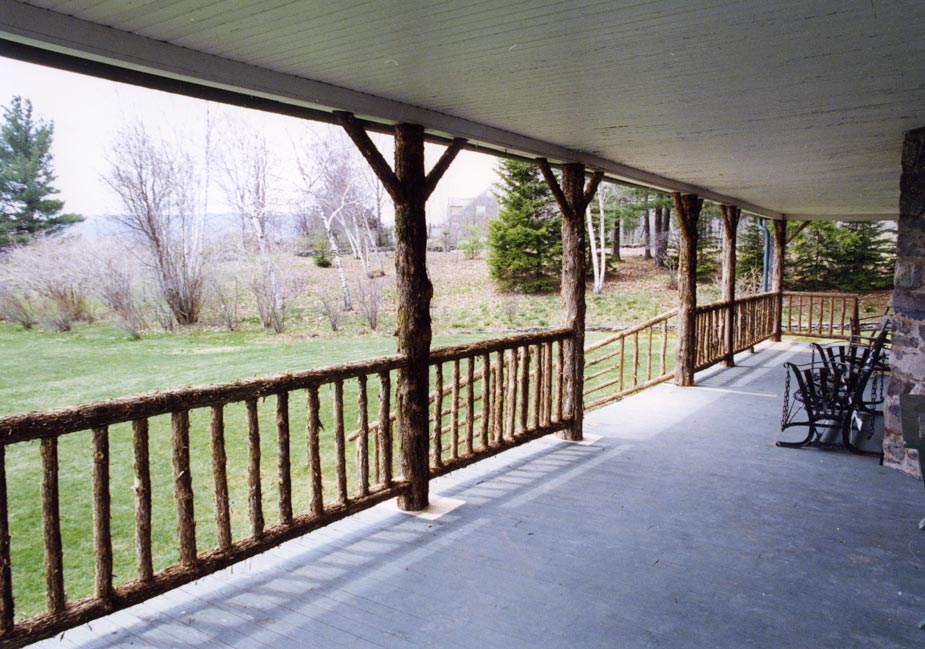 Natural wood deck railings built with trees and branches titled Classic Deck Rails
