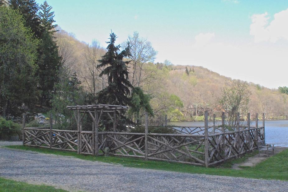 Garden fencing built in the rustic style using logs and branches titled Tuxedo Park Garden