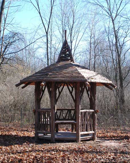 Rustic gazebo built using bark-on trees and branches titled the Lime Gazebo
