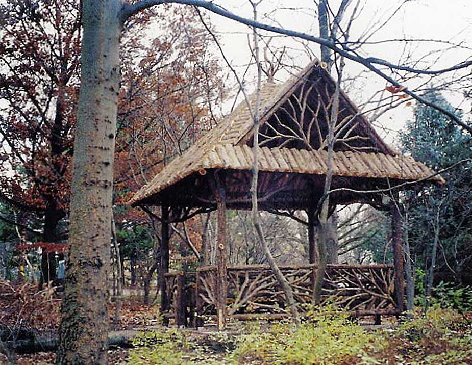 A large rustic pavilion built using bark-on trees and branches at Missouri Botanical Garden