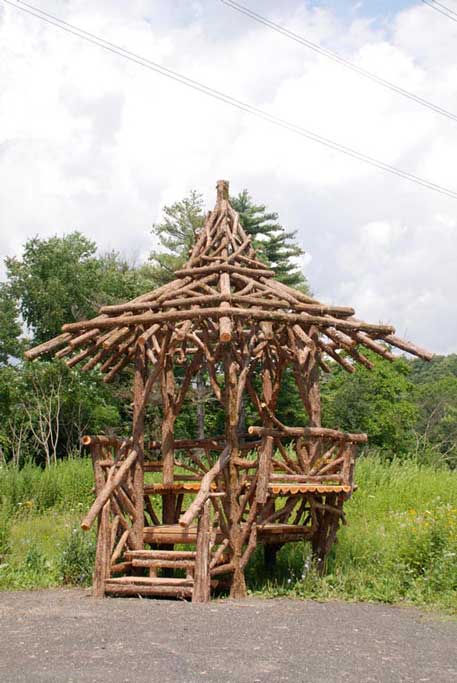 Unique rustic garden gazebo built using bark-on trees and branches titled the Unger House