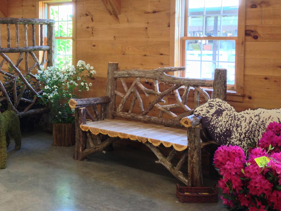 Outdoor park bench built in the rustic style using logs and branches titled the Country Living
