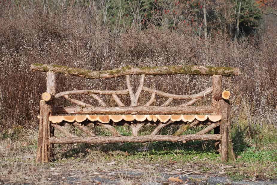 Rustic bench custom built using cedar trees and branches titled the Haddem