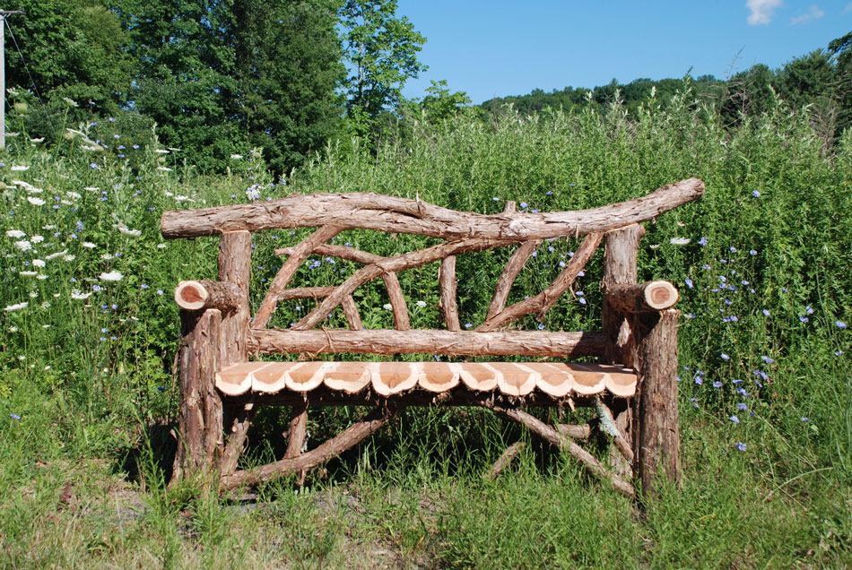 Exterior twig bench built from cedar logs titled the Primose