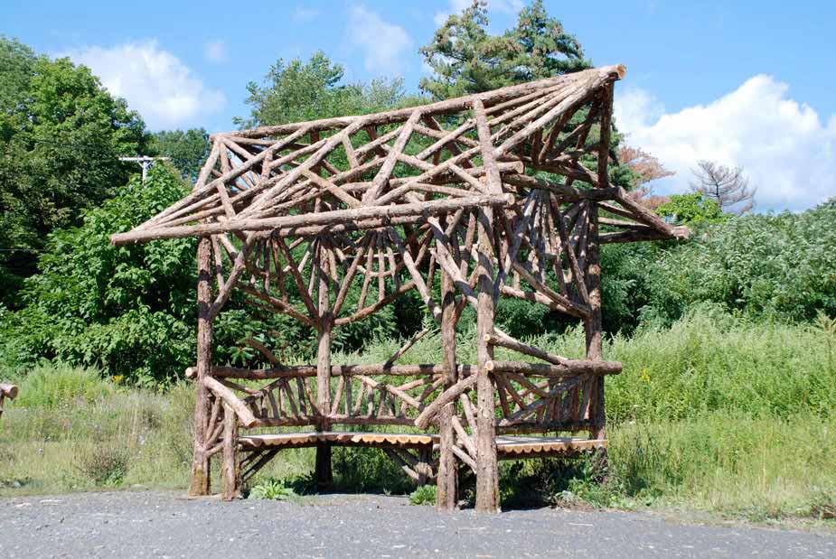 Outdoor sitting shelter built in the rustic style using logs and branches built for Disney Resort in Florida